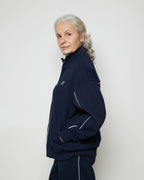 Бомбер вільного крою на блискавці з білими кантами